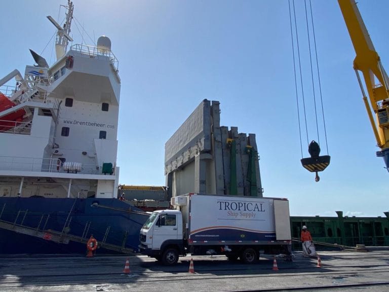 Tropical Ship Supply truck under the ship crane hook during a stores delivery