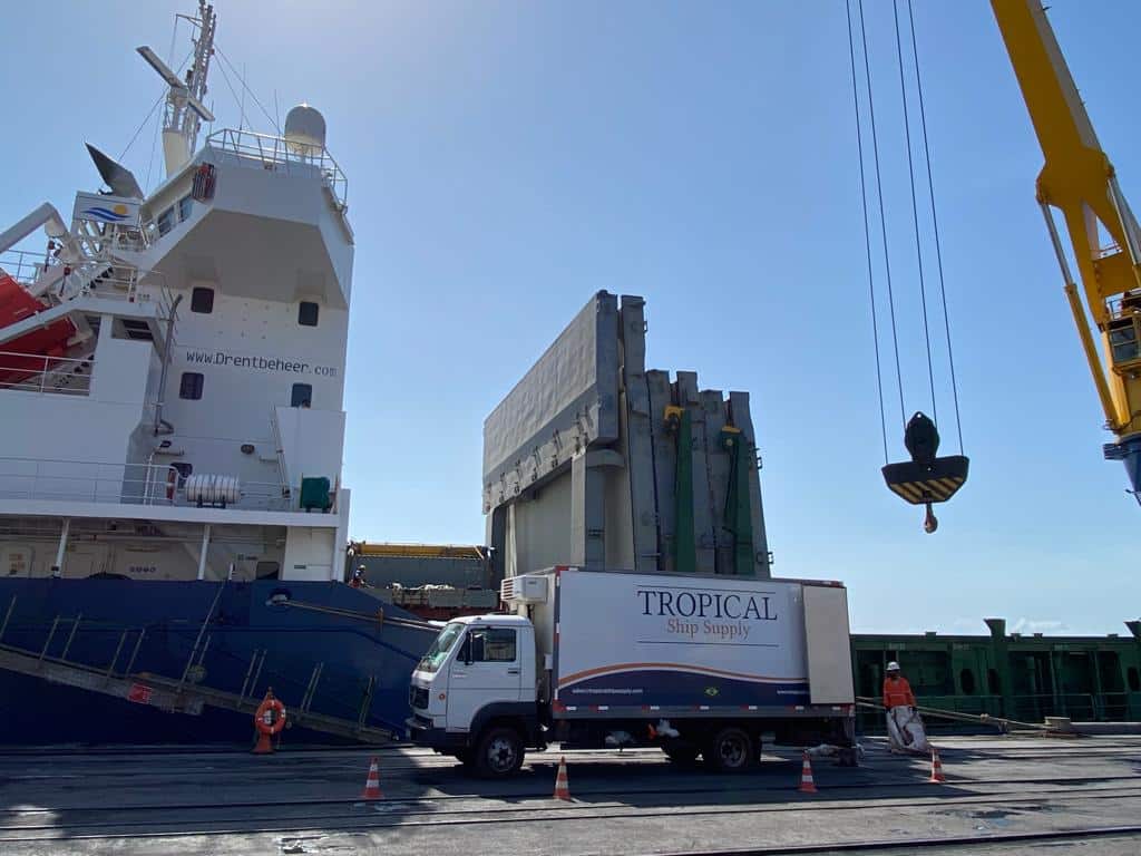 Tropical Ship Supply truck under the ship crane hook during a stores delivery