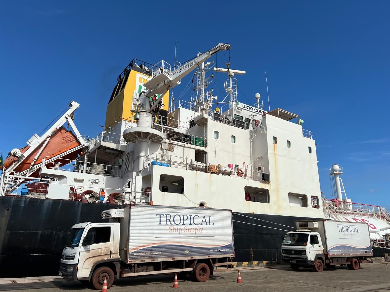 Cargo and offshore vessels being supplied at a Brazilian port at sunrise
