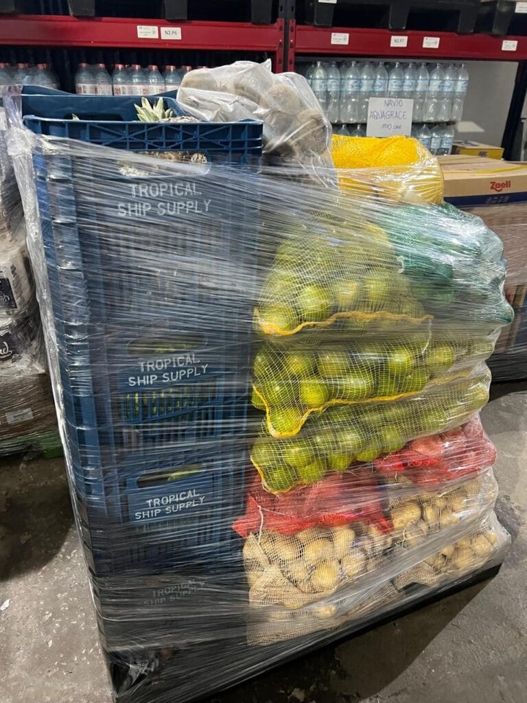 Wrapped pallet of fresh fruit and vegetables ready for delivery on board